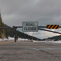 Still from The Trail Ridge Road is Closed, of a barrier with a 'Road Closed' sign on it.